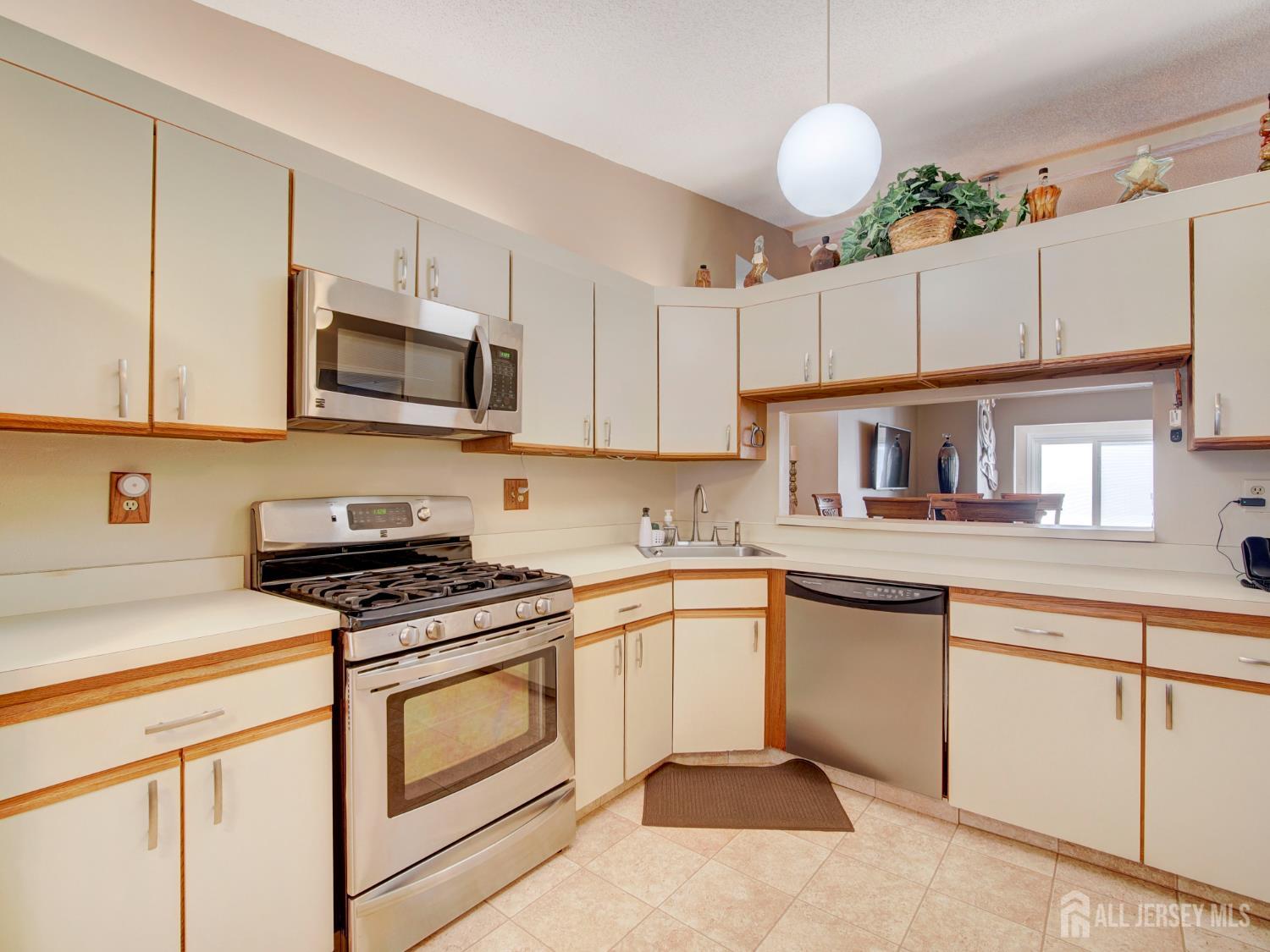 136 Wycoff Way West East Brunswick, NJ 08816 - Photo 8 of 28 a kitchen with cabinets stainless steel appliances and wooden floor