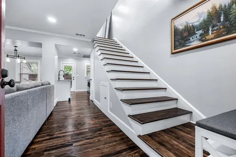 a view of entryway and hall with wooden floor