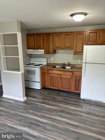 a kitchen with granite countertop stainless steel appliances and wooden cabinets