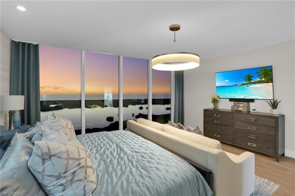 13945 Old Coast Road, Unit 1906 Naples, FL 34110 - Photo 28 of 40 a bedroom with a bed and a television
