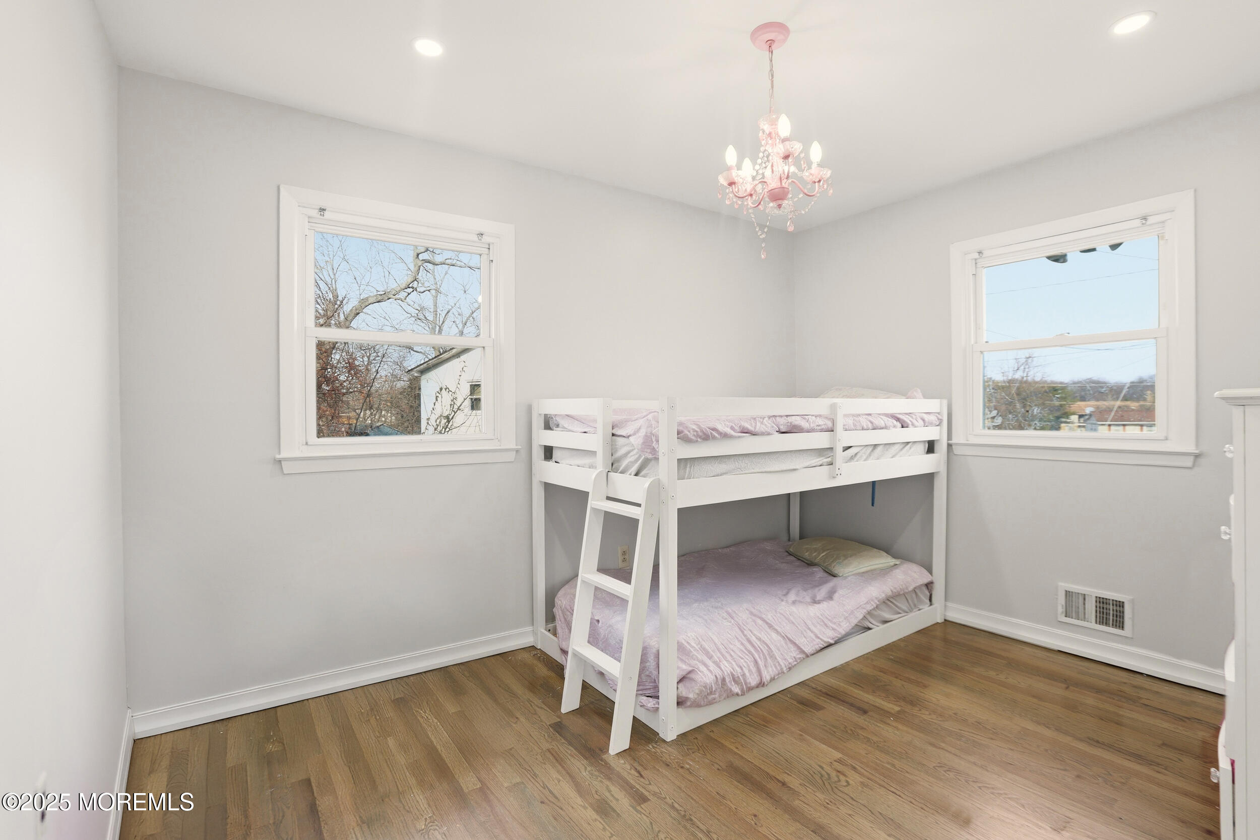 7 Citadel Court Jackson, NJ 08527 - Photo 16 of 29 a view of a room with wooden floor a chandelier a wooden table and chairs