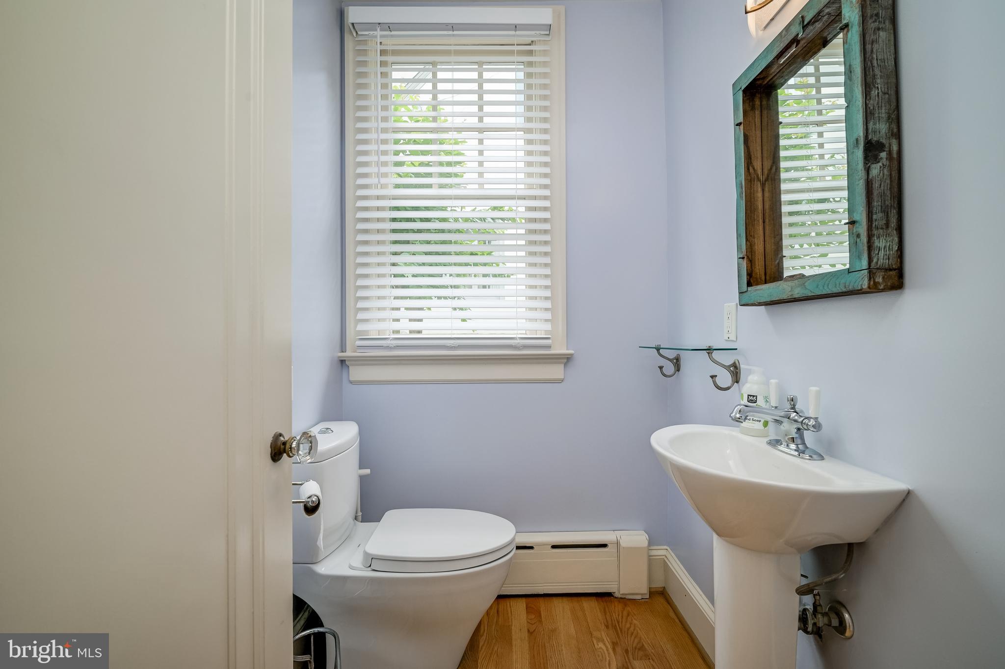 3608 Spring Street Chevy Chase, MD 20815 - Photo 12 of 38 a bathroom with a toilet sink and mirror