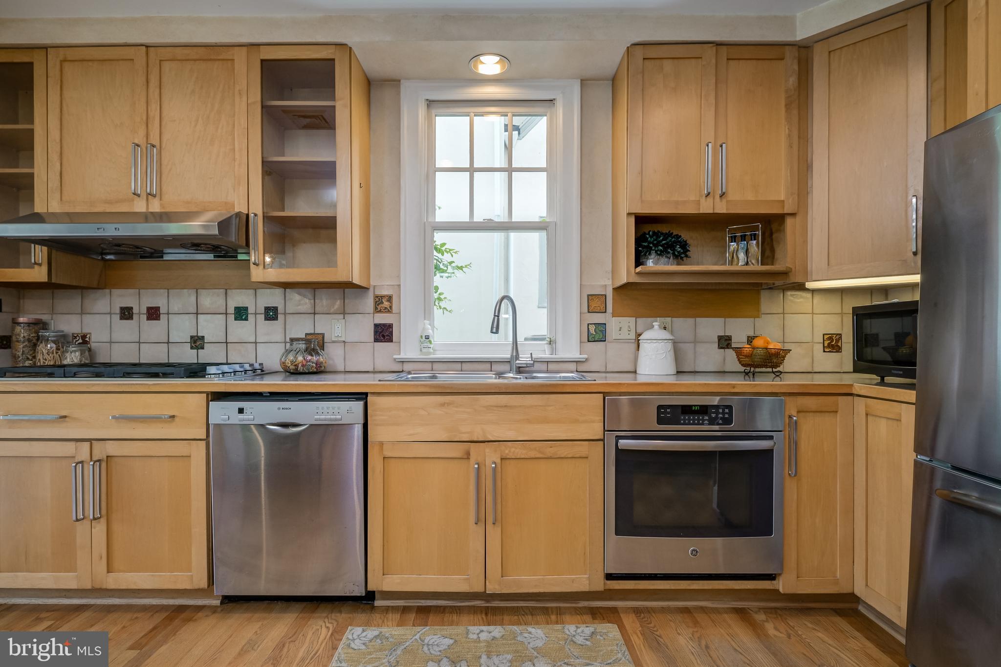 3608 Spring Street Chevy Chase, MD 20815 - Photo 13 of 38 a kitchen with stainless steel appliances granite countertop a stove a sink and a microwave