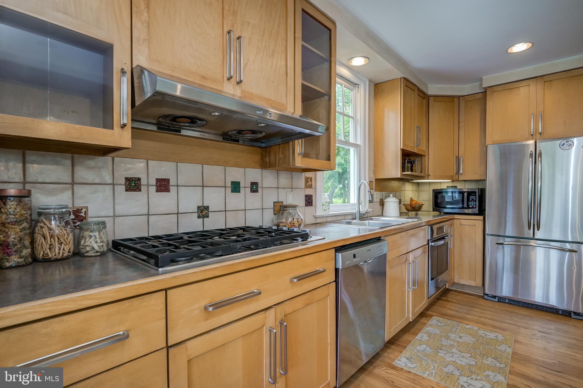 3608 Spring Street Chevy Chase, MD 20815 - Photo 15 of 38 a kitchen with stainless steel appliances granite countertop a stove a sink and a refrigerator