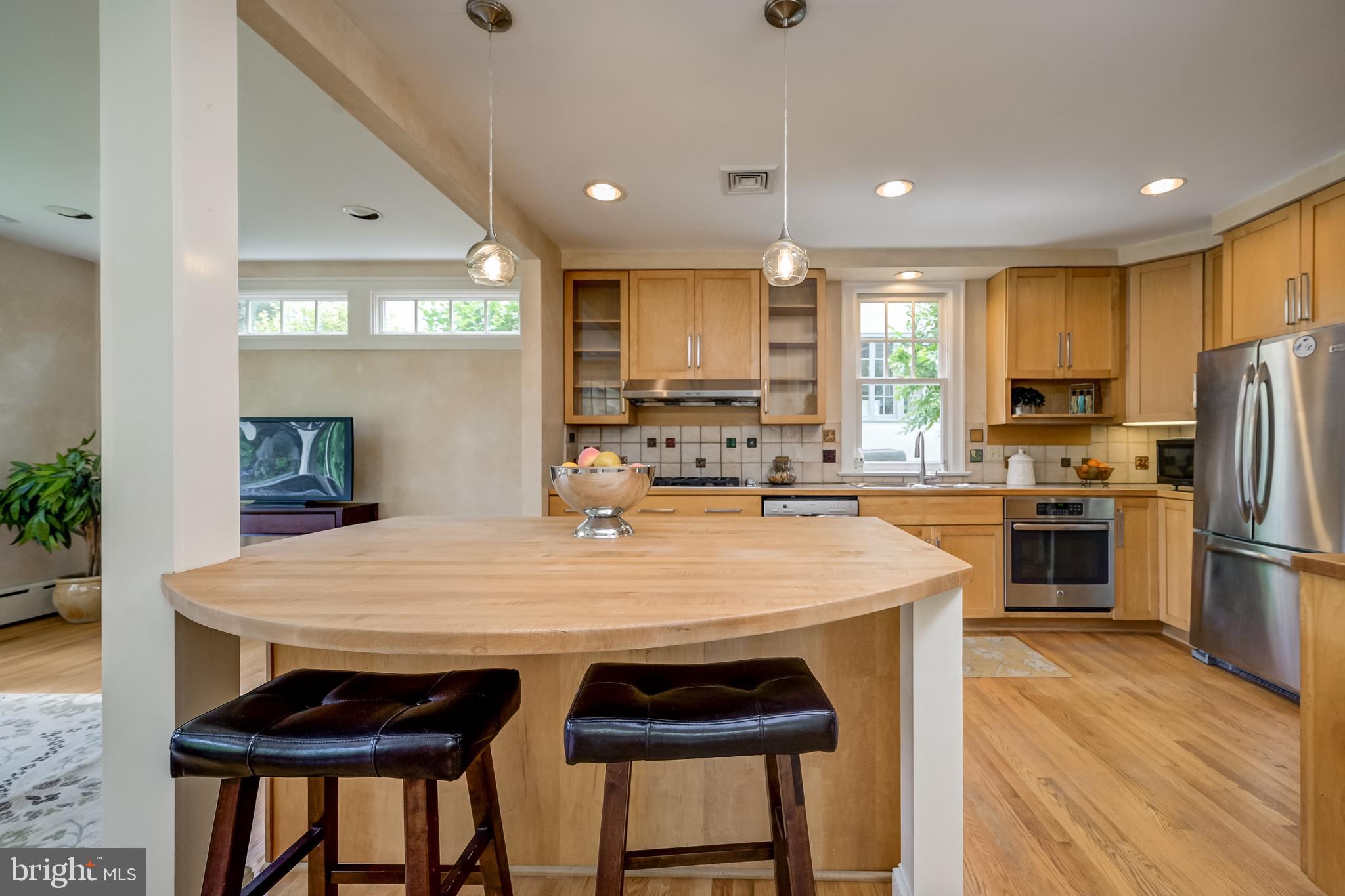 3608 Spring Street Chevy Chase, MD 20815 - Photo 16 of 38 a kitchen with refrigerator a stove a sink and a refrigerator