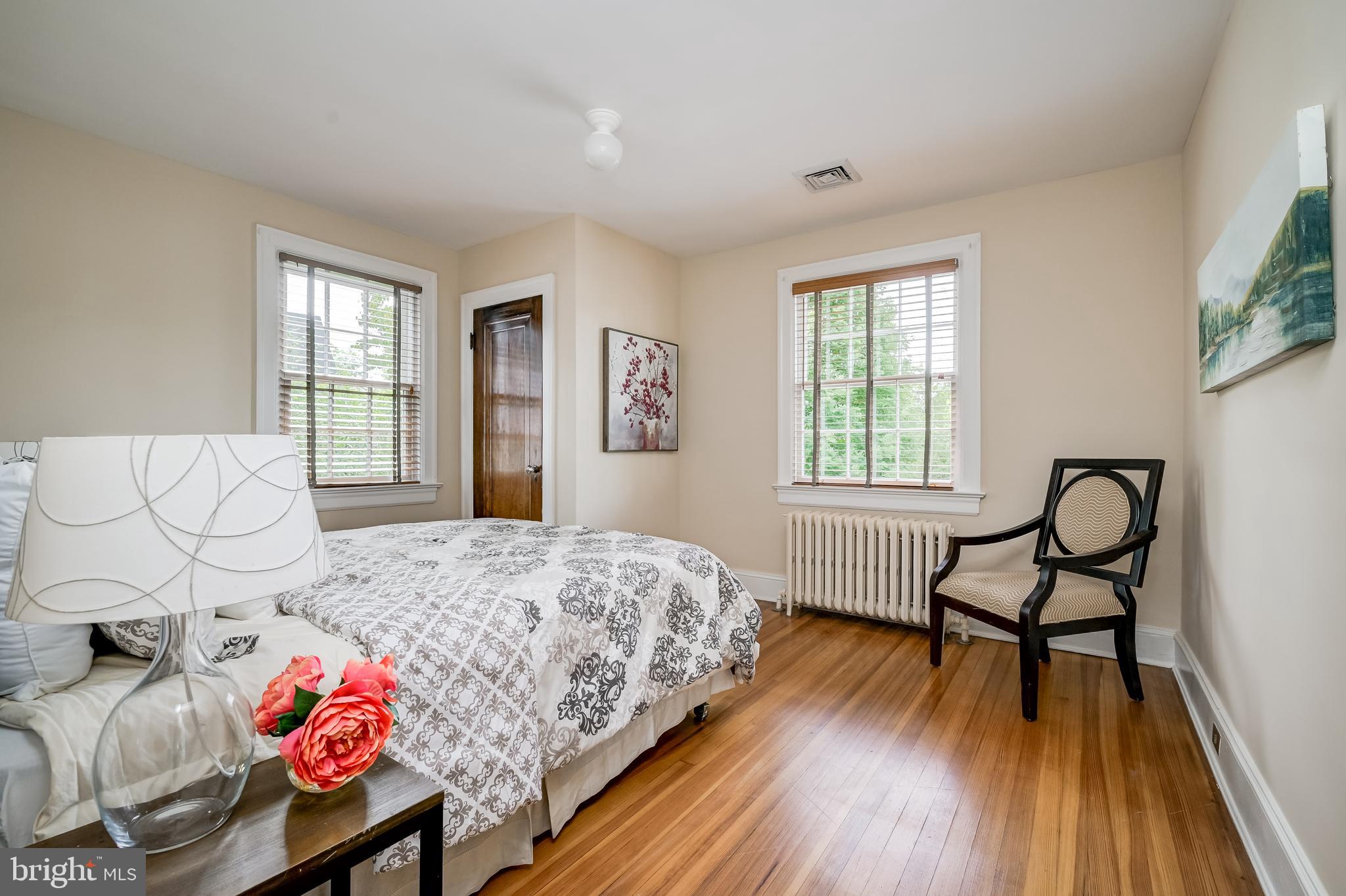 3608 Spring Street Chevy Chase, MD 20815 - Photo 22 of 38 a bedroom with a bed and wooden floor