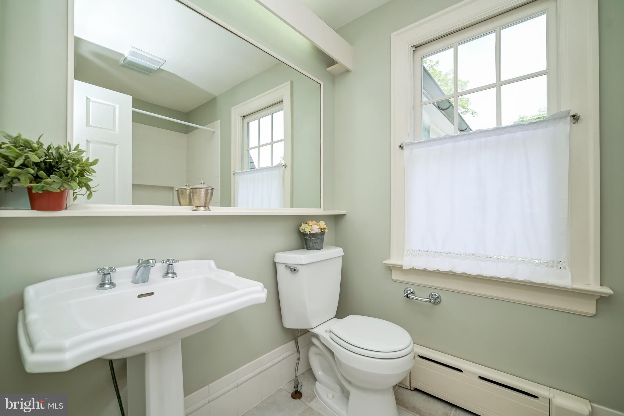 3608 Spring Street Chevy Chase, MD 20815 - Photo 26 of 38 a bathroom with a sink toilet and a mirror