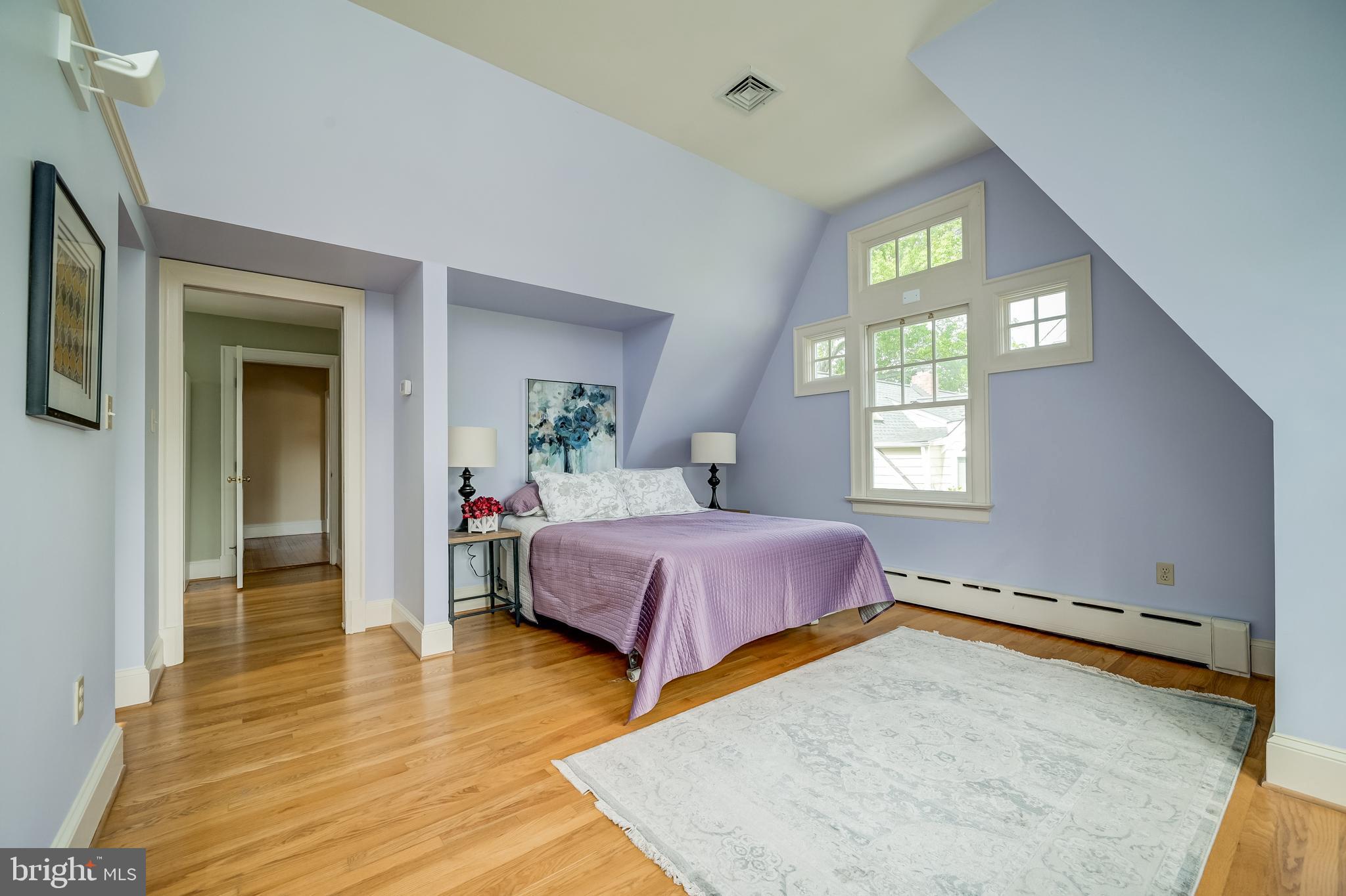 3608 Spring Street Chevy Chase, MD 20815 - Photo 29 of 38 a spacious bedroom with a bed and wooden floor
