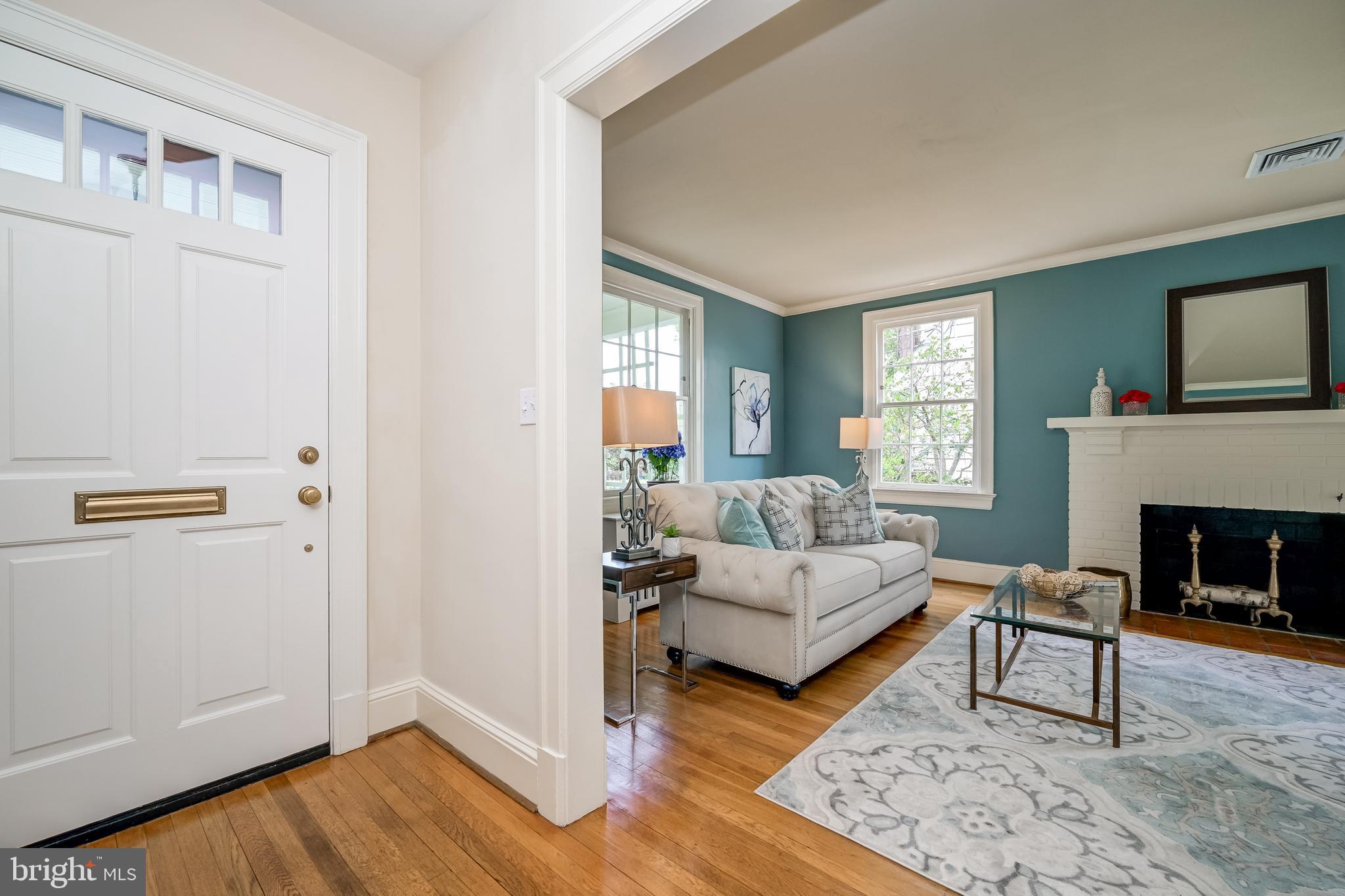 3608 Spring Street Chevy Chase, MD 20815 - Photo 6 of 38 a living room with furniture and a fireplace