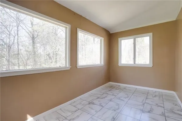 a view of an empty room with a window