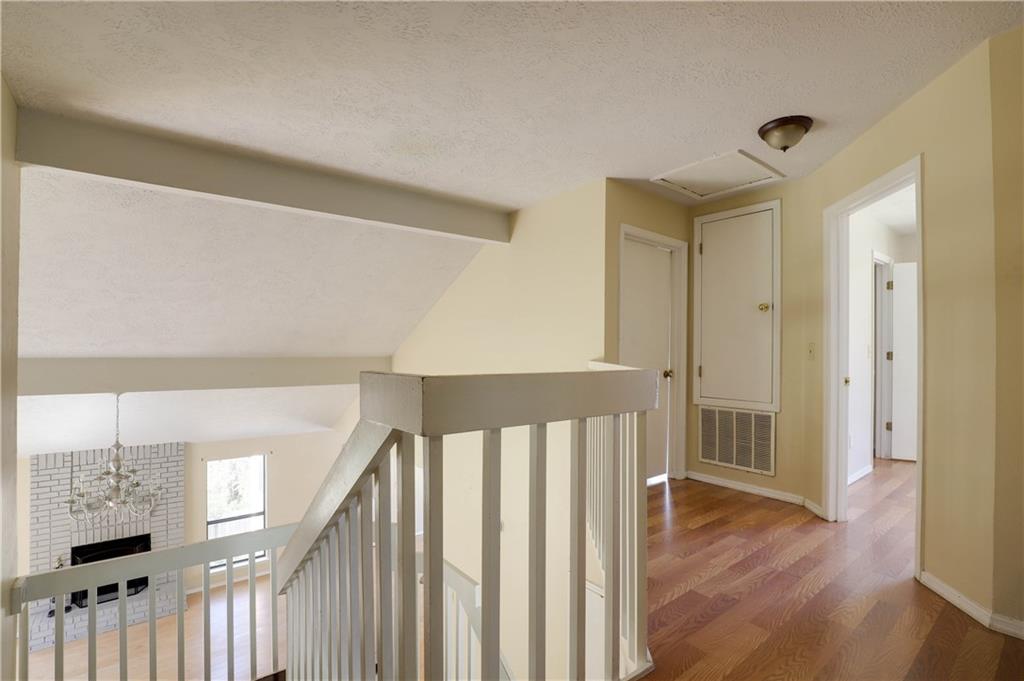 7043 Ivy Pointe Row Austell, GA 30168 - Photo 17 of 36 a view of a hallway with wooden floor and staircase