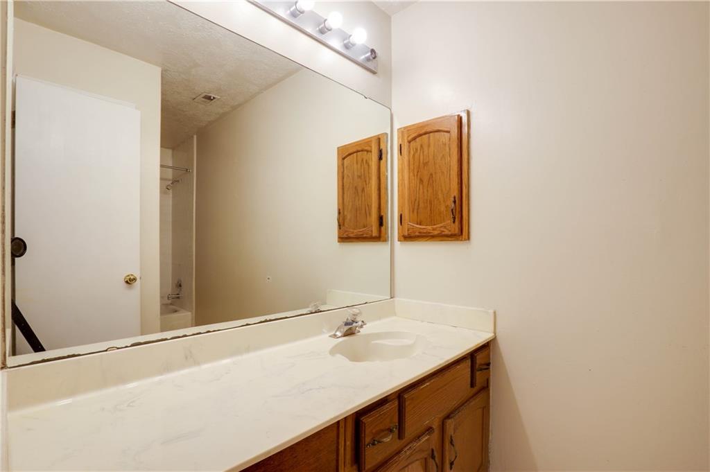 7043 Ivy Pointe Row Austell, GA 30168 - Photo 22 of 36 a bathroom with a sink and a mirror
