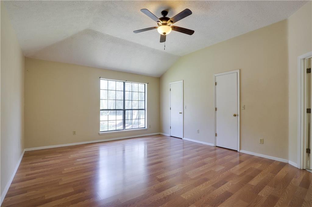 7043 Ivy Pointe Row Austell, GA 30168 - Photo 23 of 36 a view of empty room with wooden floor and fan