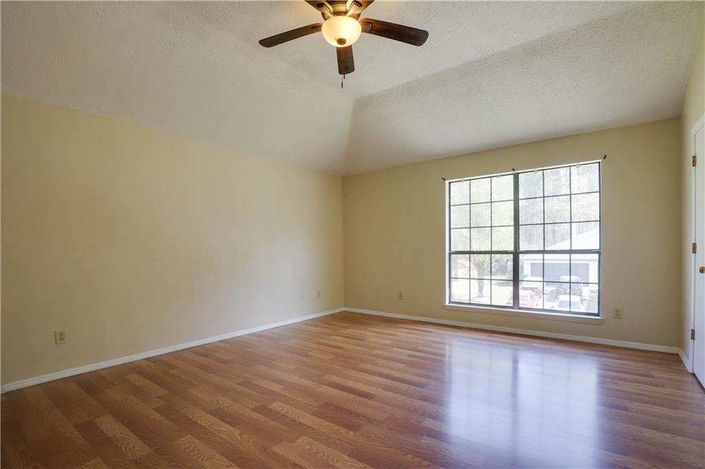 7043 Ivy Pointe Row Austell, GA 30168 - Photo 25 of 36 wooden floor in an empty room with a window