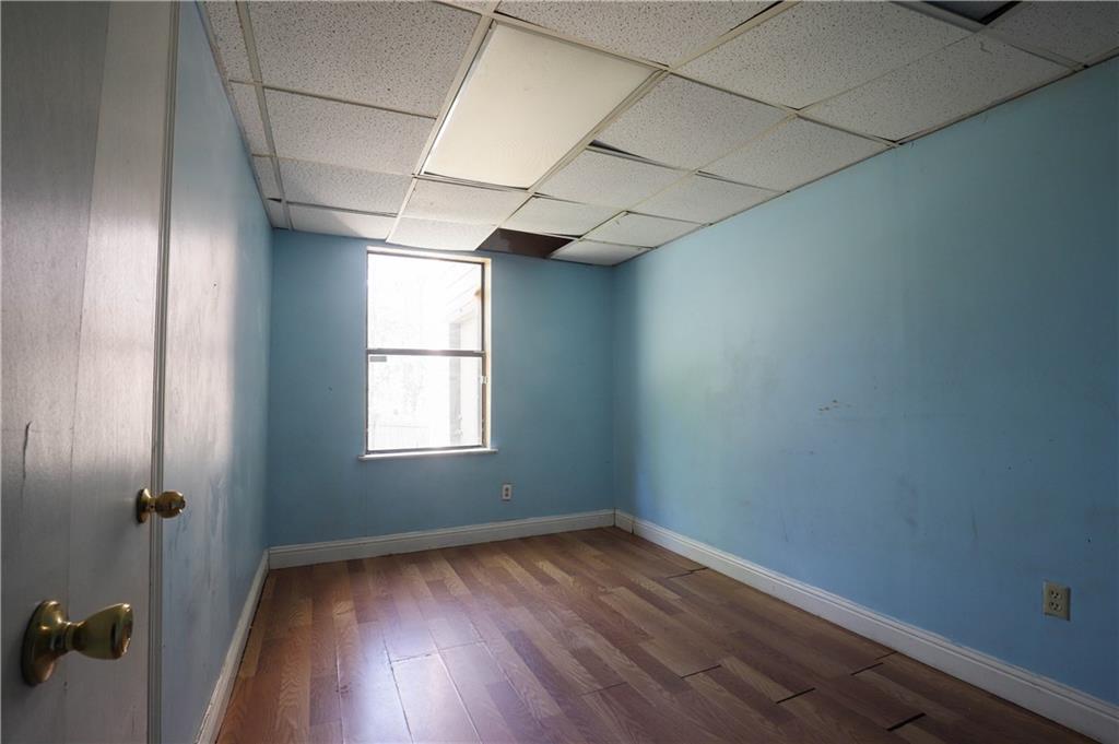 7043 Ivy Pointe Row Austell, GA 30168 - Photo 32 of 36 an empty room with wooden floor and windows