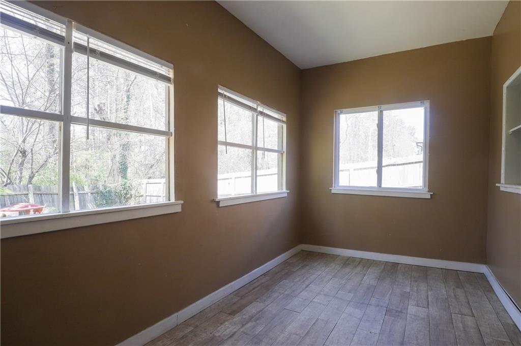 7043 Ivy Pointe Row Austell, GA 30168 - Photo 36 of 36 a view of an empty room with wooden floor and a window