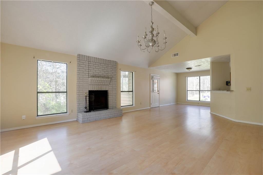7043 Ivy Pointe Row Austell, GA 30168 - Photo 7 of 36 an empty room with windows and fireplace