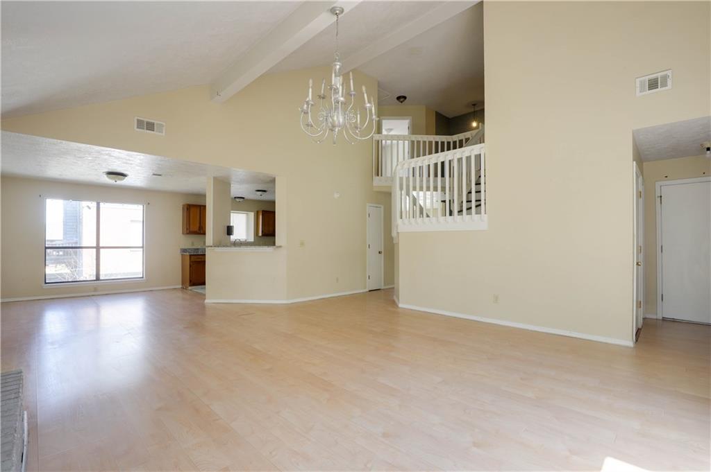 7043 Ivy Pointe Row Austell, GA 30168 - Photo 8 of 36 an empty room with windows and entryway