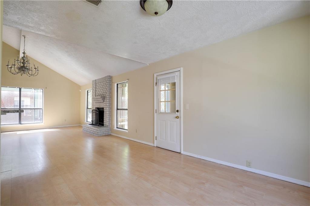 7043 Ivy Pointe Row Austell, GA 30168 - Photo 10 of 36 a view of an empty room with chandelier and a window