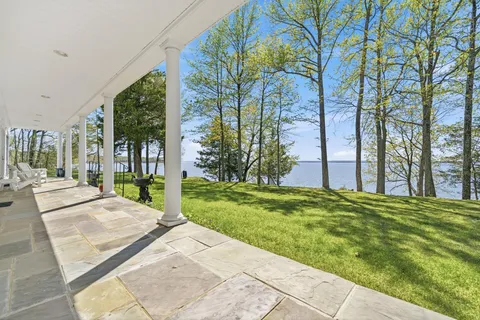 a dining room with furniture a fireplace and wooden floor