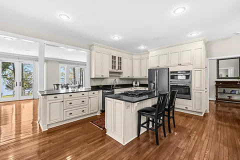 a bed sitting in a spacious bedroom next to a window
