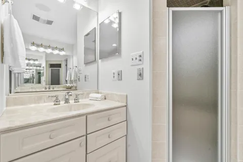 a bathroom with double vanity sinks and a mirror