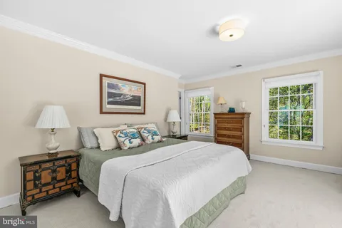 a bedroom with a bed and a mirror