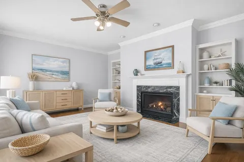 a kitchen with stainless steel appliances a stove a sink dishwasher a dining table and chairs with wooden floor