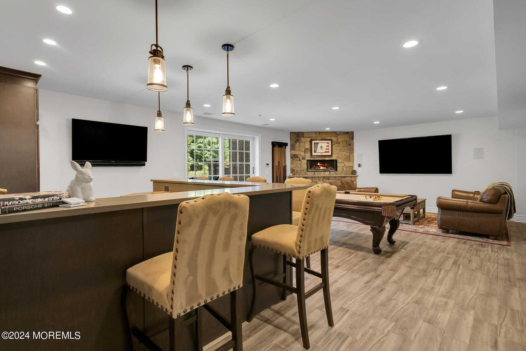 147 Heulitt Road Colts Neck, NJ 07722 - Photo 38 of 49 a living room with furniture a flat screen tv and kitchen view