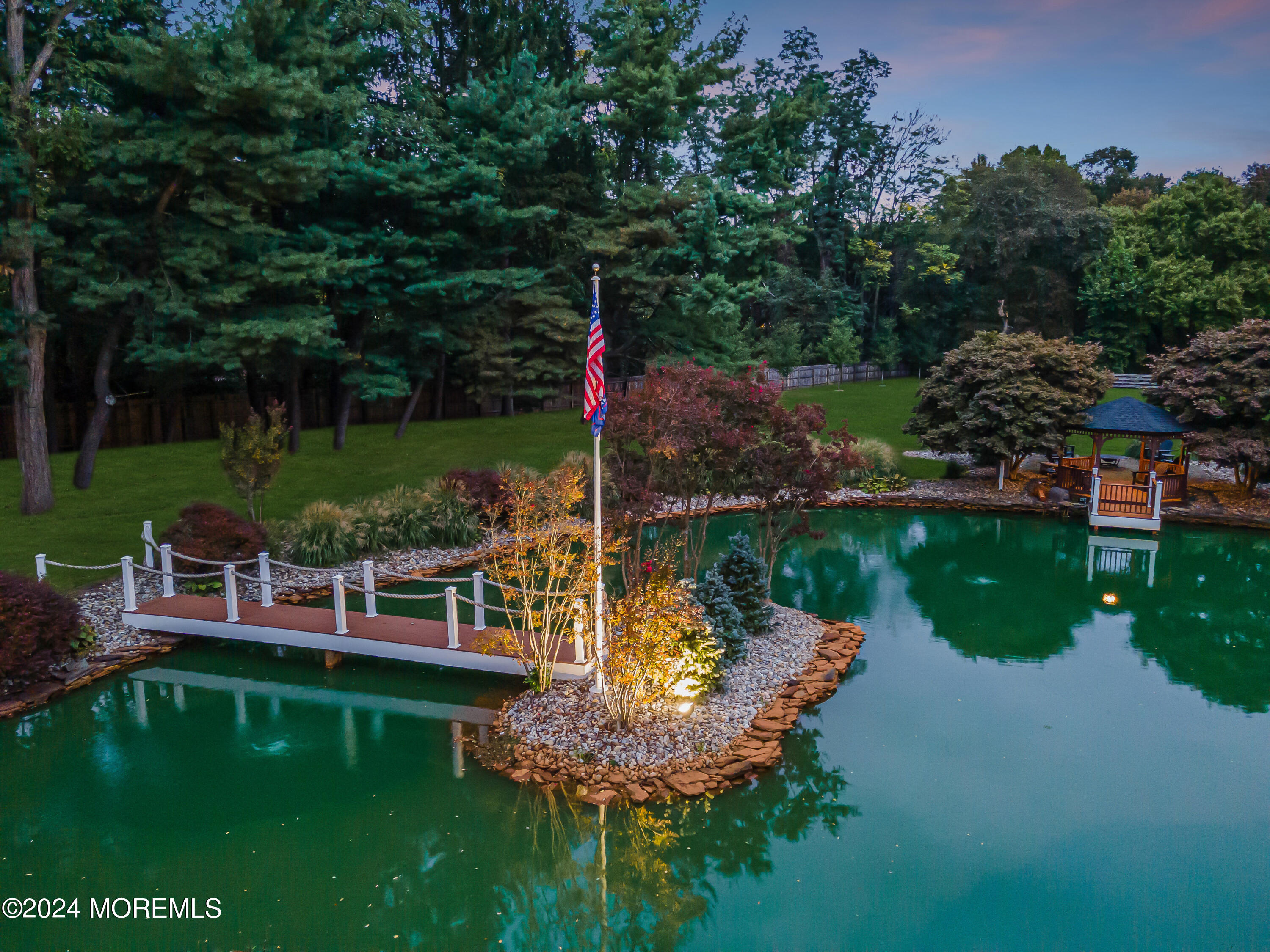 147 Heulitt Road Colts Neck, NJ 07722 - Photo 46 of 49 a view of a lake with a garden and swimming pool