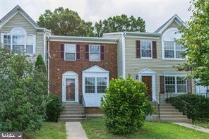 17929 Milroy Drive Dumfries, VA 22026 - Photo 1 of 8 a front view of a house with a yard and trees