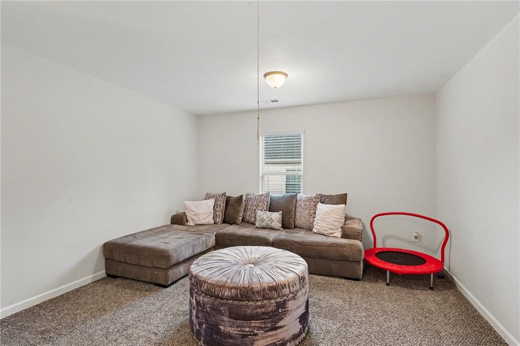 1241 England Terrace Hampton, GA 30228 - Photo 15 of 20 a living room with furniture and a couch