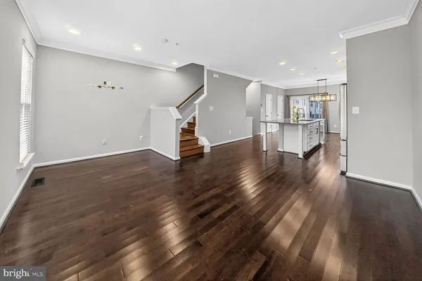 a view of empty room with wooden floor and window