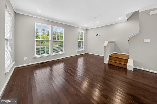 a view of a livingroom with wooden floor and window