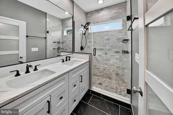 a bathroom with double sink and mirror