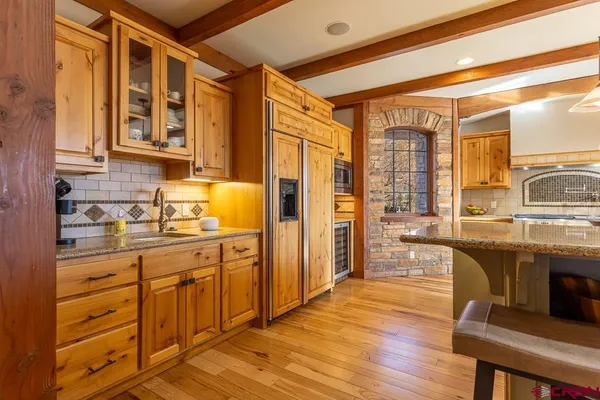 a spacious bathroom with a granite countertop sink and a large mirror