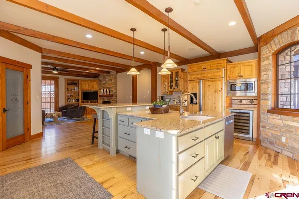a kitchen with stainless steel appliances kitchen island granite countertop a sink and cabinets