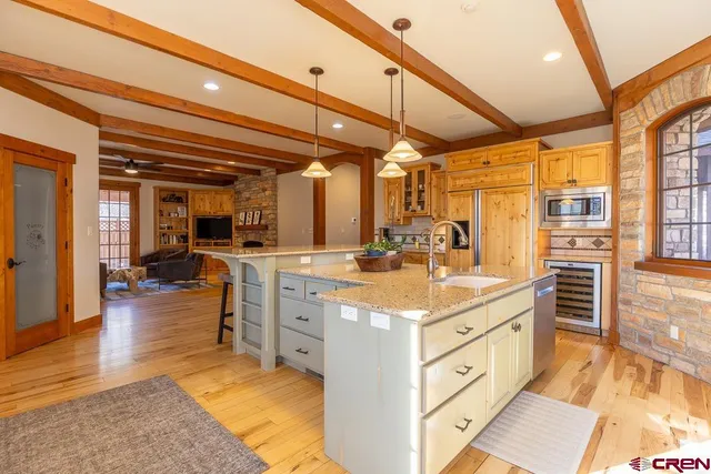 a kitchen with stainless steel appliances kitchen island granite countertop a sink and cabinets