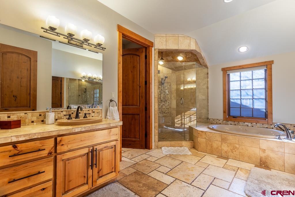 80 Twilight Trails Circle Durango, CO 81301 - Photo 17 of 35 a spacious bathroom with a double vanity sink a mirror and a shower
