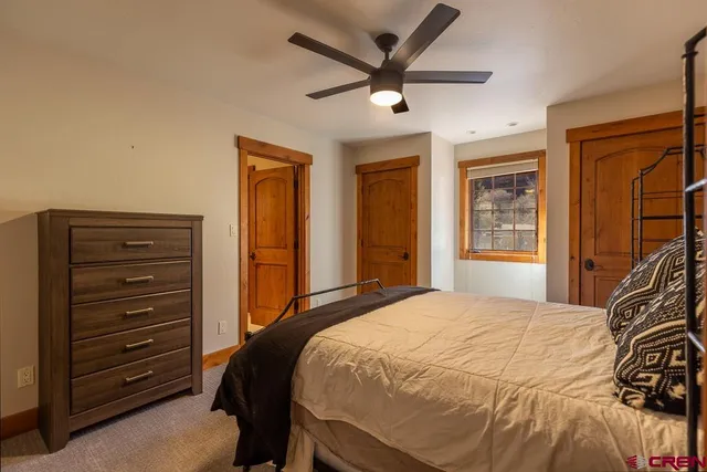 a bedroom with a bed and a dresser