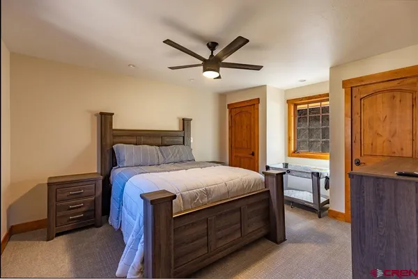 a bedroom with a bed and a chandelier