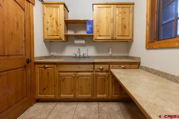 a kitchen with stainless steel appliances granite countertop a sink window and cabinets