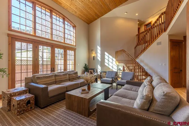 a living room with furniture and large windows