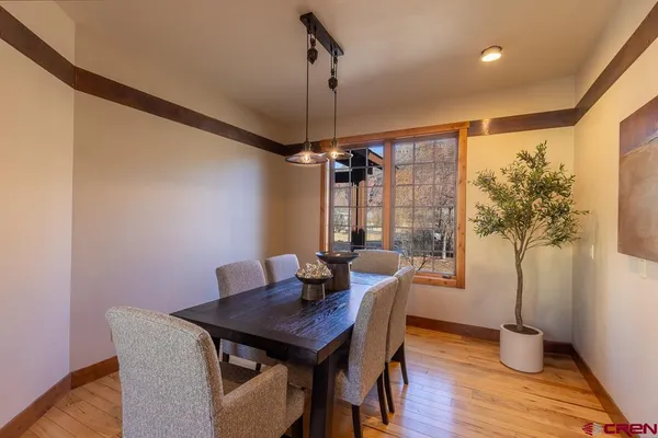 a view of a dining room with furniture window and wooden floor