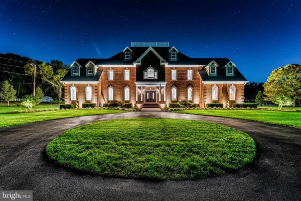 a front view of a house with a garden and plants