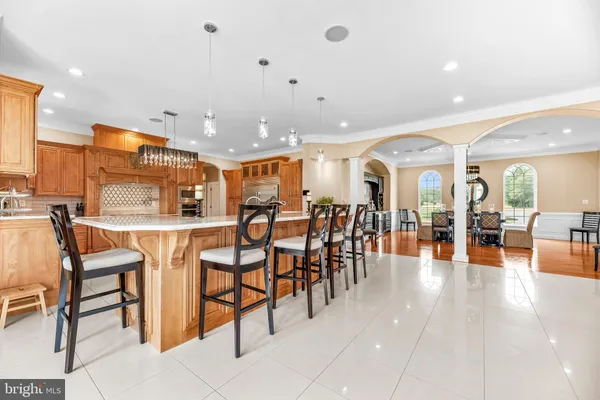 a living room with furniture dining table and a large window