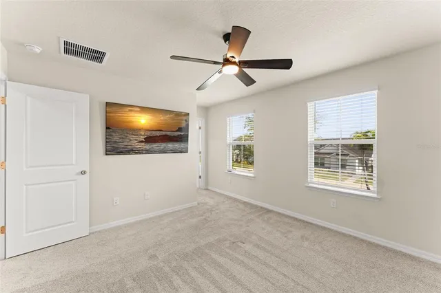 a view of an empty room with a window and a flat screen tv