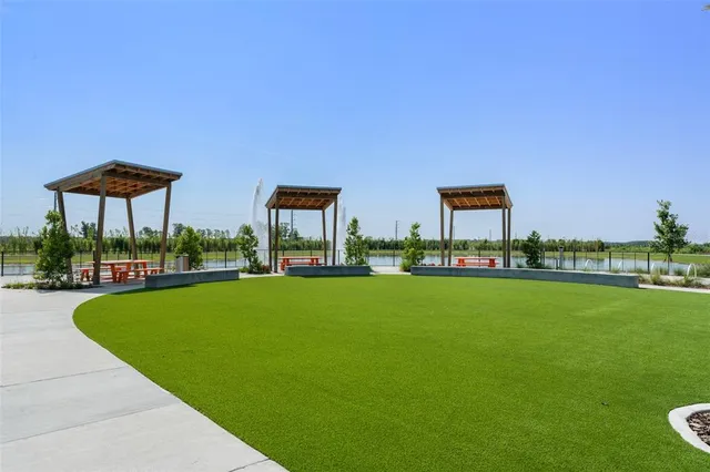 a view of a swimming pool and lounge chairs