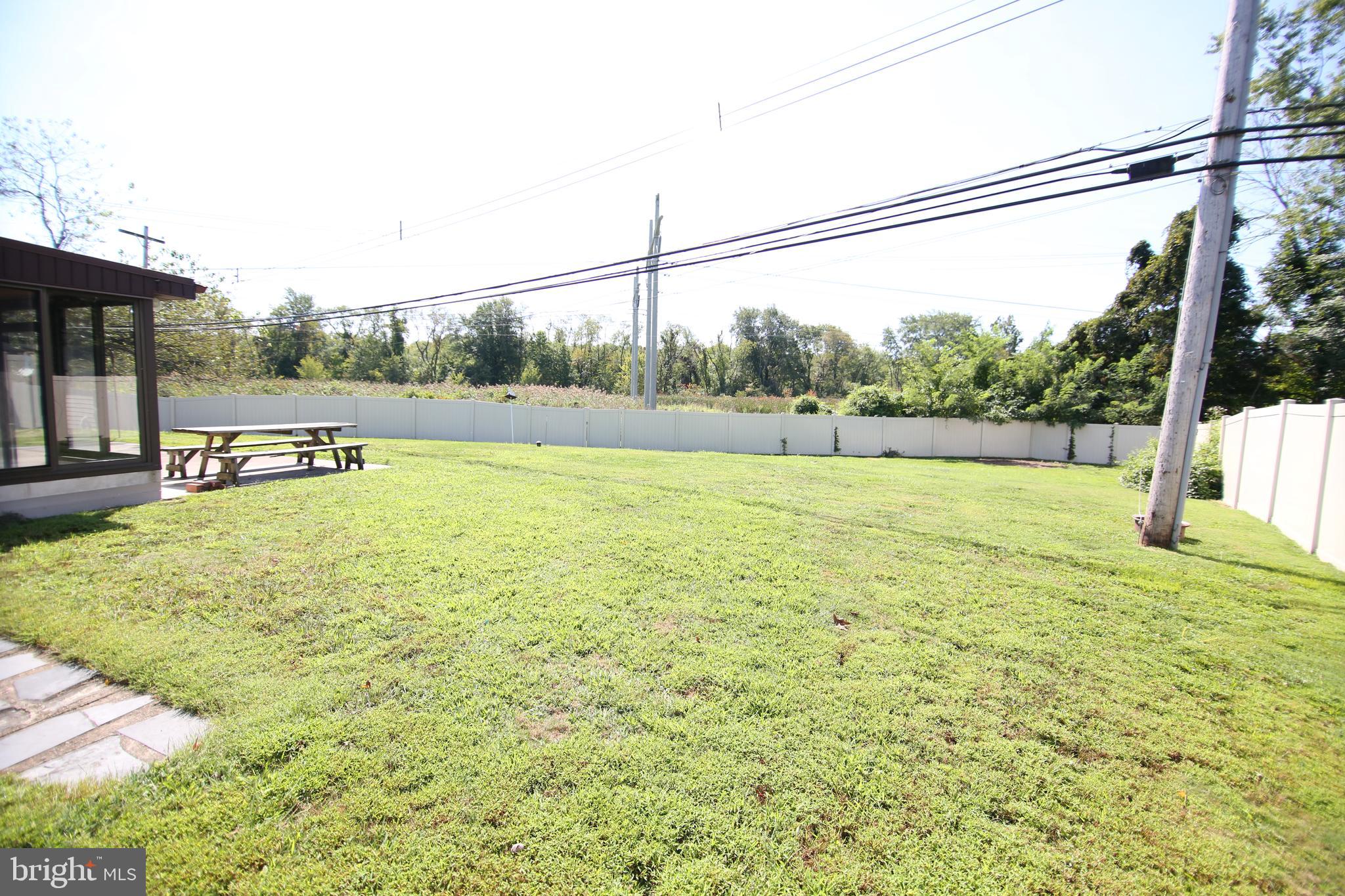 23 Vineyard Road Levittown, PA 19057 - Photo 30 of 30 6' PVC privacy fence around sprawling rear yard