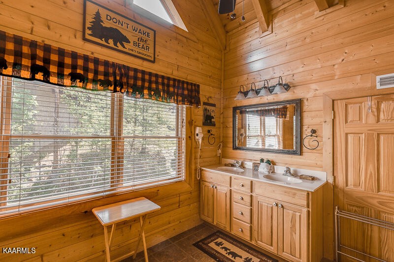 1304 Timberwolf Way Sevierville, TN 37876 - Photo 22 of 36 a bathroom with a sink and a large mirror